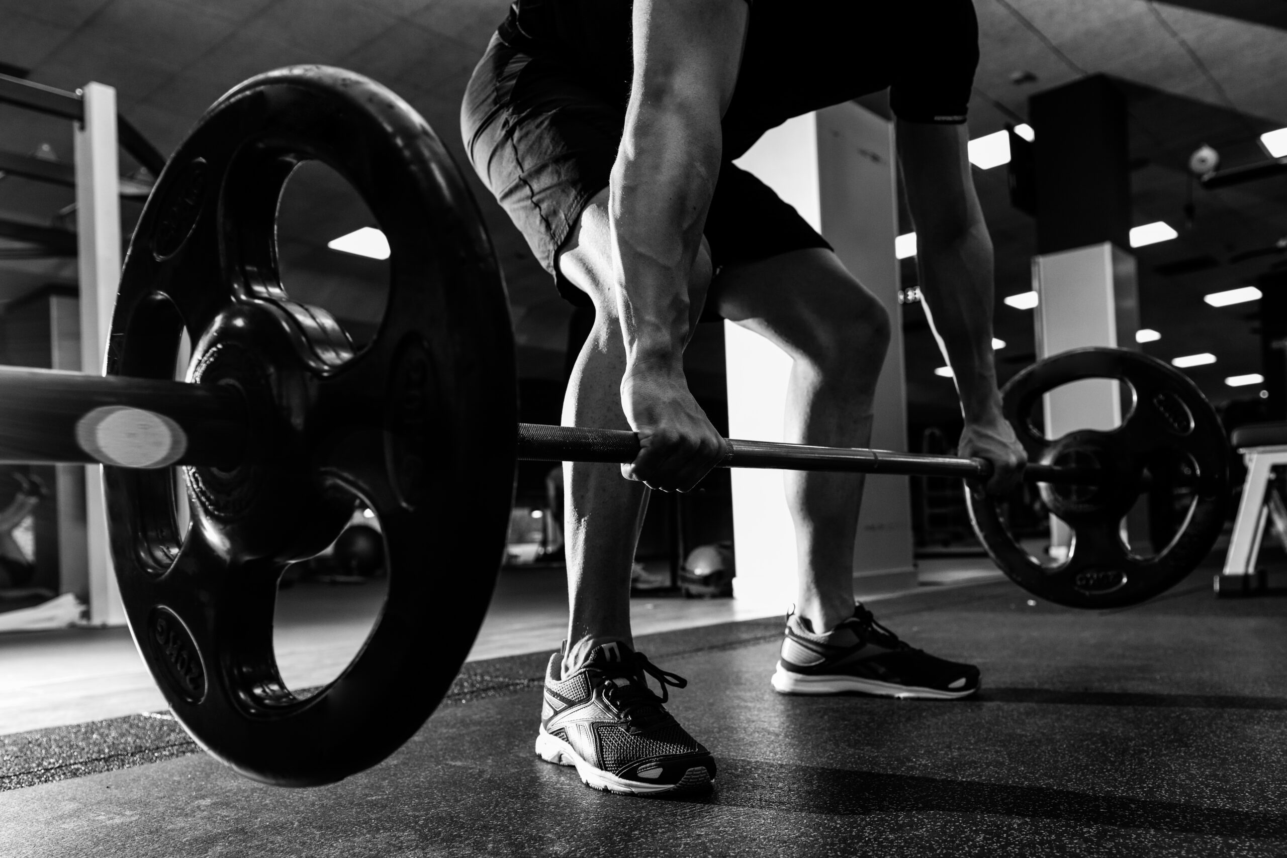 closeup of weightlift workout at the gym with barbell.